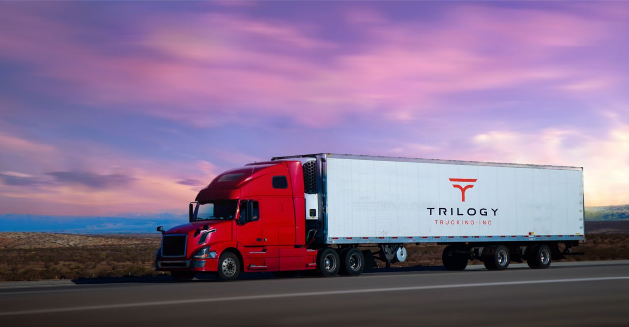 Trilogy Trucking red Volvo semi-truck